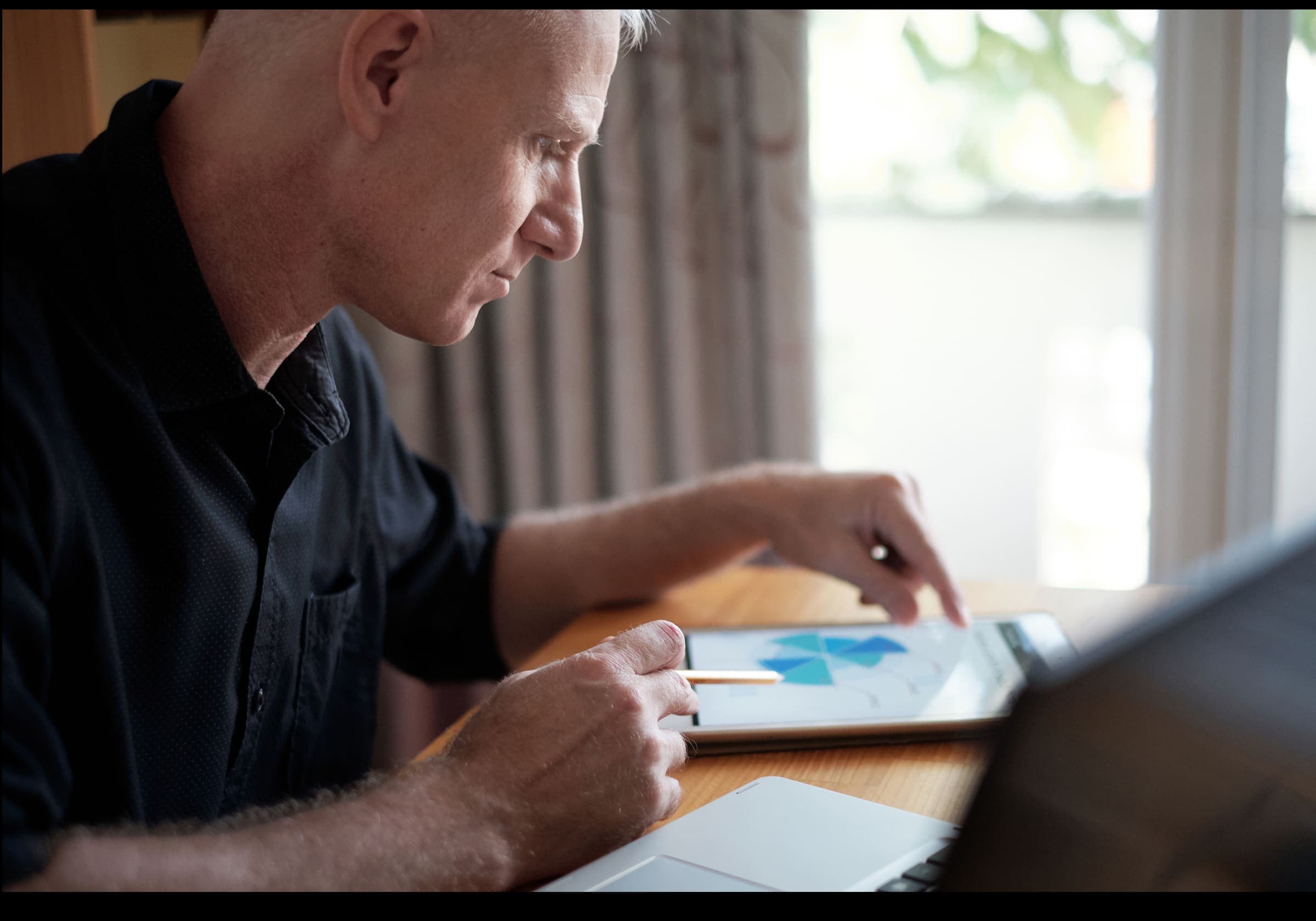 Engineer reviewing charts on a tablet at a desk