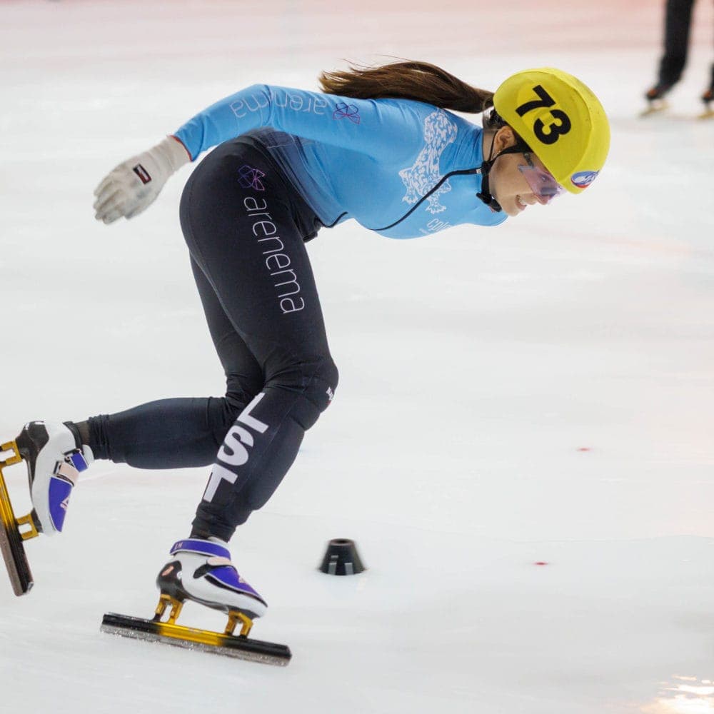 Short track speed skater leaning into a turn